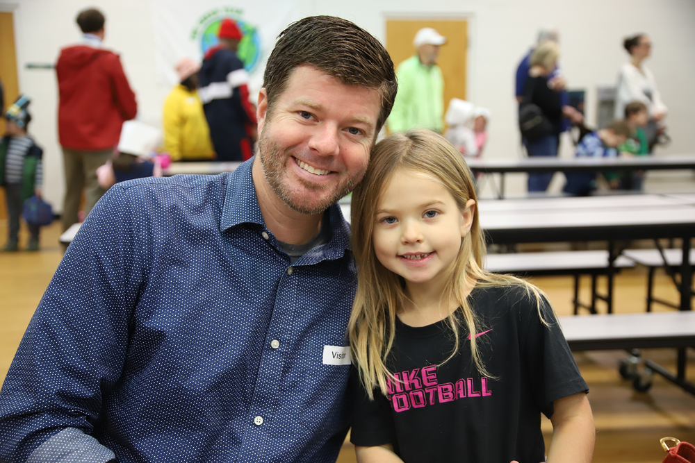 Father and daughter participate in the annual Thanksgiving Feast!